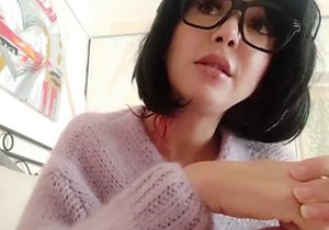 Glasses-wearing mature geek shows her goodies